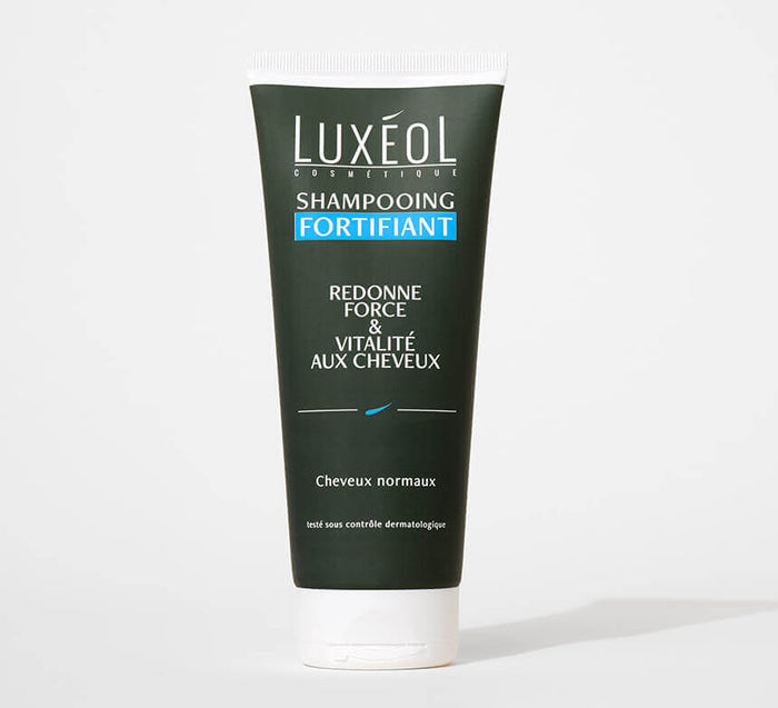 Luxéol Strengthening Shampoo 200 ml tube on minimal background for strength and vitality.

