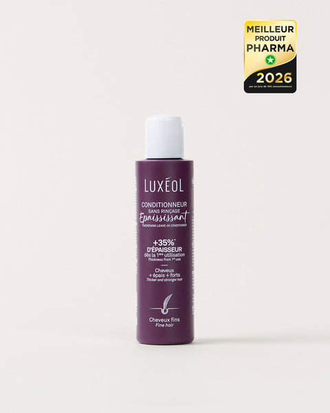 Purple bottle of Luxeol hair product on a white background with a gold and black award label.