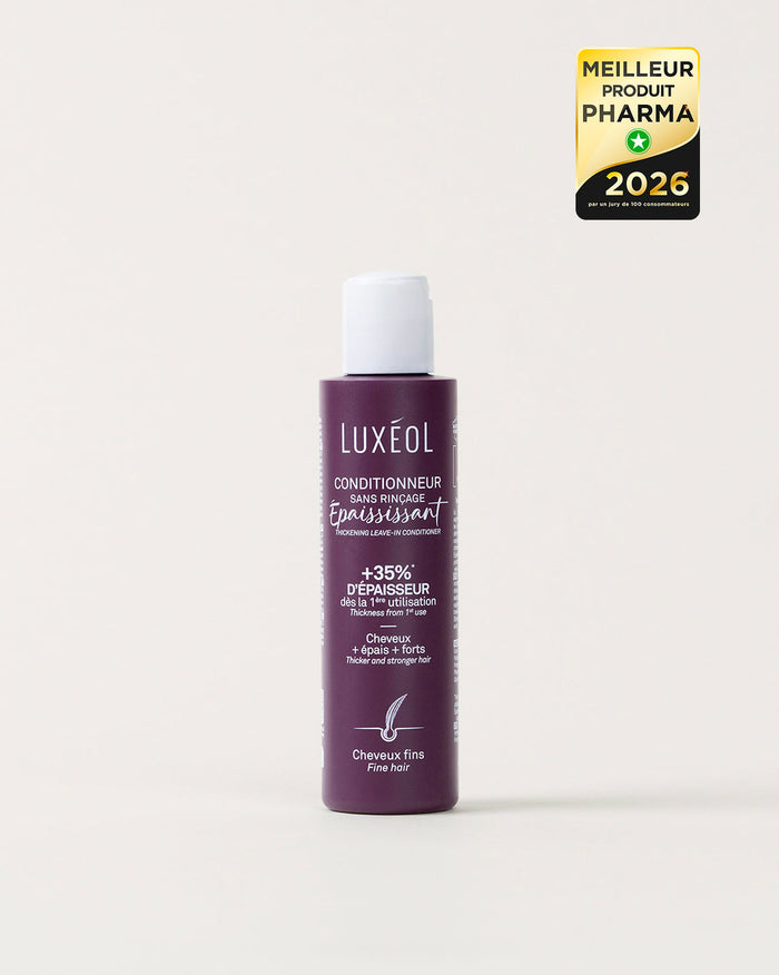 Purple bottle of Luxeol hair product on a white background with a gold and black award label.