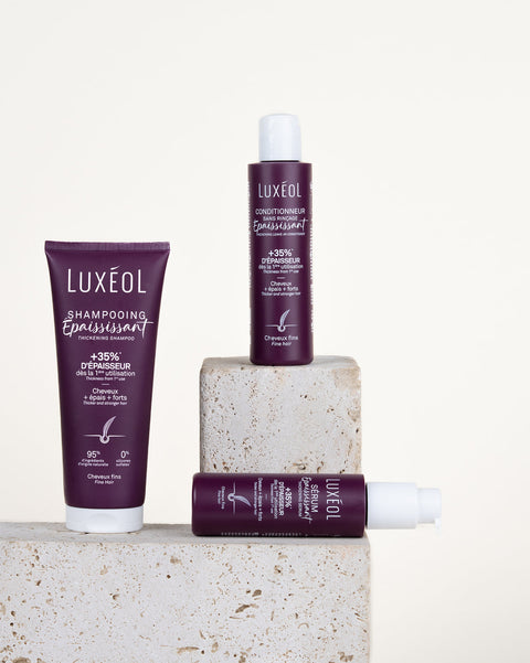Luxéol matu kopšanas produkti uz akmens bloka ar baltu fonu